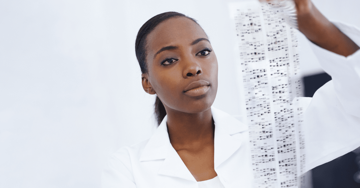 Black woman reading results from genetic testing